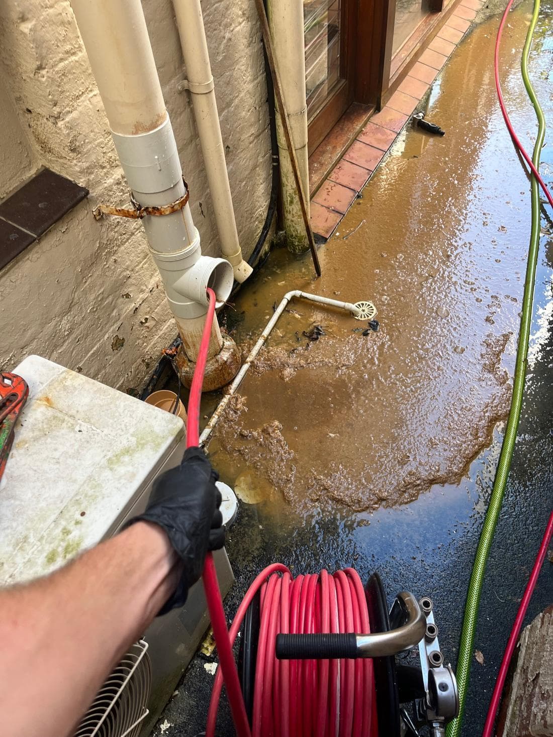 High-pressure jetting clearing a blocked drain